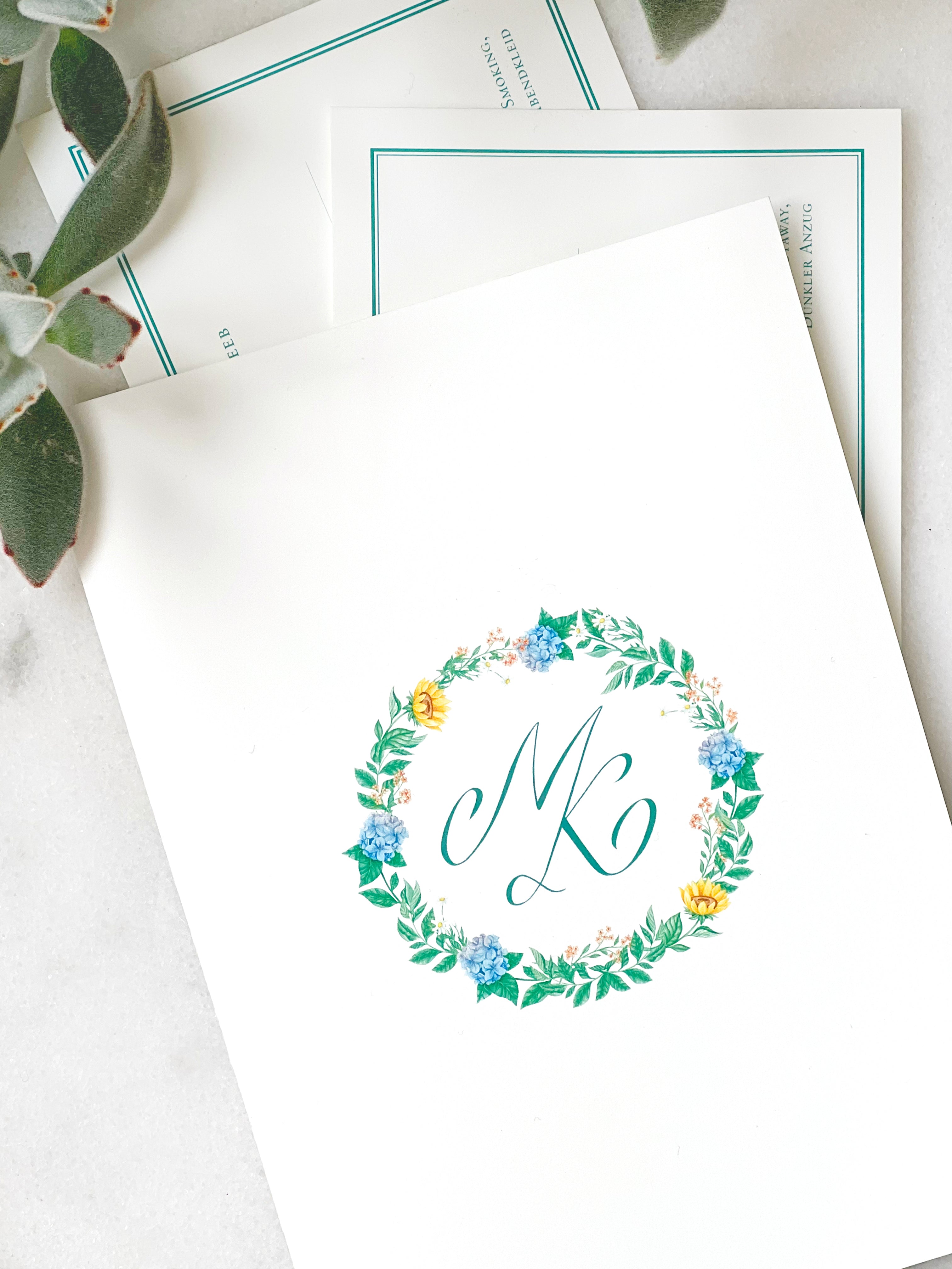 Personalised wedding invitations and stationery featuring delicate but hot summer watercolour flowers and a beautiful calligraphy monogram, M and K