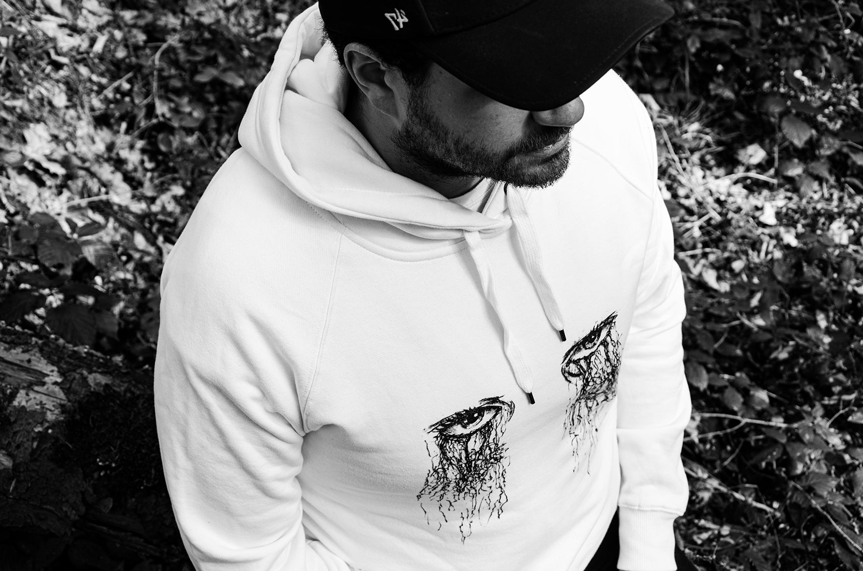 White Hoodie with silk-screen-printed ink illustration of eyes, being worn, high-quality artistic pullovers, for a cool, bold statement 02