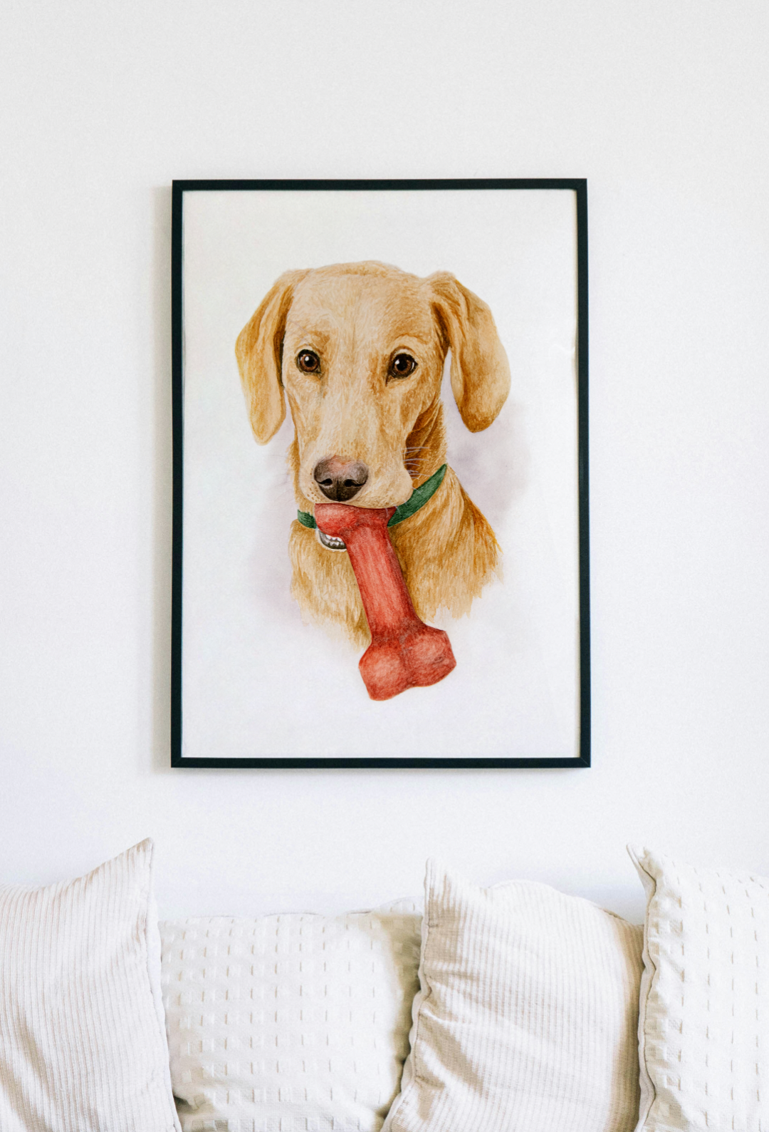 A framed and hanged, original piece of a watercolour portrait of a Labrador dog, with unique artistic details on paper