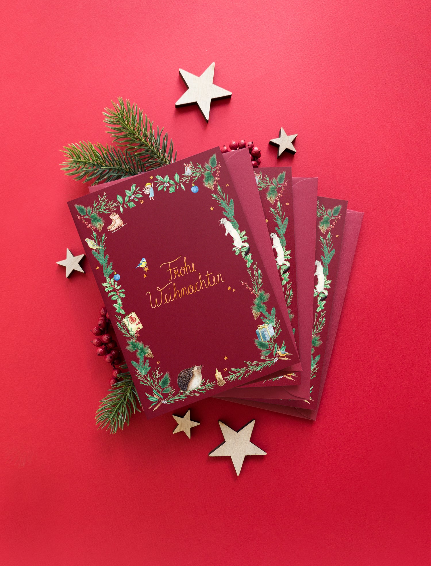 Christmas stationery inspired by forest animals, plants and an angel, painted in watercolour and printed on high-quality paper by Huber und Lerner. Showing a greeting card in red 01